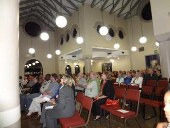 people sitting in a church listening to a choir